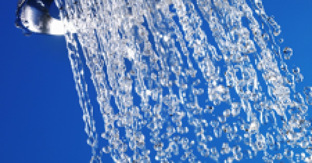 A high-pressure chrome shower head with flowing water